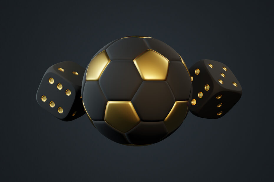 Uma bola de futebol ao centro da imagem e dois dados, um de cada lado, todos da cor preta com detalhes dourado. Ao fundo, a imagem também é preta.